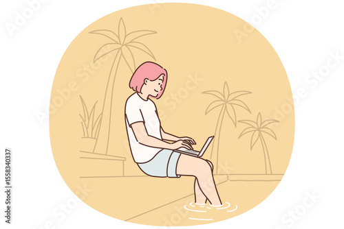 Woman freelancer working with laptop sitting on beach under palm tree or near pool in resort hotel