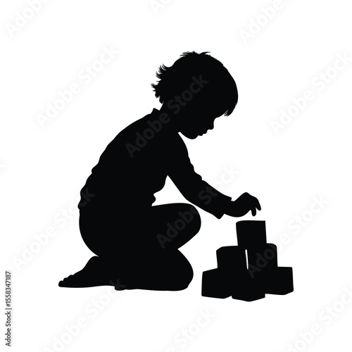 Silhouette of a child sitting and playing with building blocks intently focused