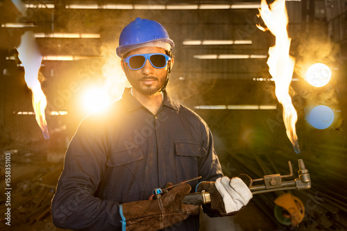 Photography Handyman preparing his autogenous welding tool in workshop.