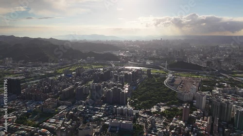 Golden Hour Aerial Taipei Cityscape with Winding River and Modern Bridges