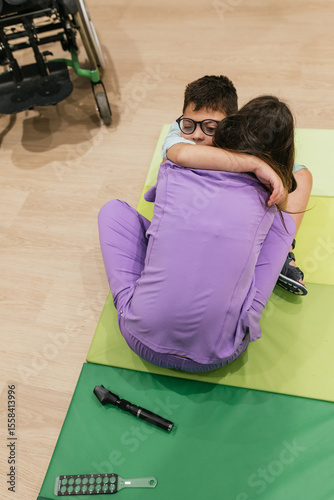 Child patient hugging optometrist after eyesight exam