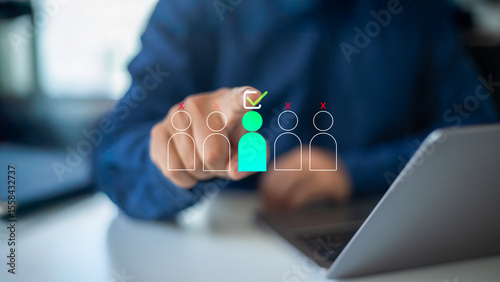 Fotografía Hand selecting a highlighted candidate icon with a checkmark among others on a virtual screen