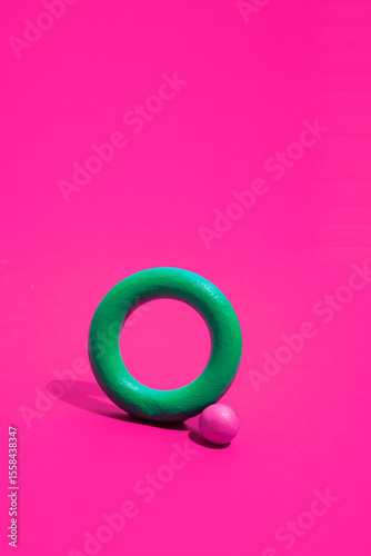 Green and magenta geometric shapes on vibrant background