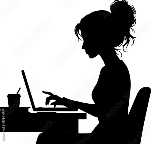 Young woman working on laptop while sitting at desk in silhouette  