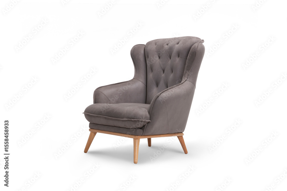 Naklejka premium An elegant wingback style armchair in a stylish grey fabric, viewed from the side. Classic design with modern wooden legs, isolated on white for projects.