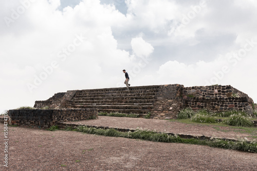 Man exploring ancient archaeological zone in Mexico