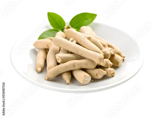 Pile of natural Safed Musli roots with green leaves, symbolizing traditional herbal health.