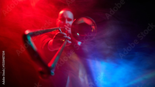 Sticker A musician plays trombone on stage under dramatic red and blue lighting