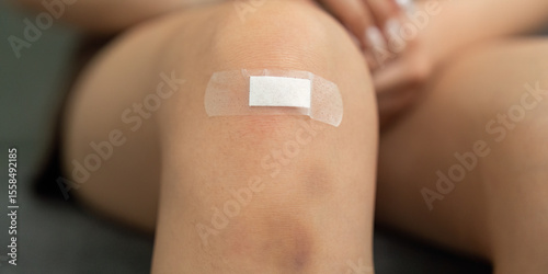 Injury Care. Close-up of a knee with a bandage applied for protection.