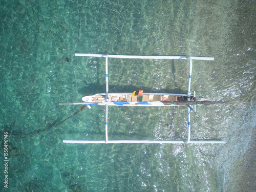 Tableau sur toile Parked typical Indonesian sailing trimaran boat. View from drone.