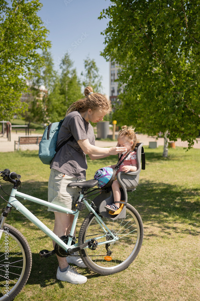 Mother and daughter in a park with a bicycle ride Mother and daughter in a park with a bicycle ride