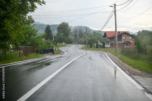Driving a car on a wet and slippery road. Wet asphalt road. Risky and dangerous driving on the road.