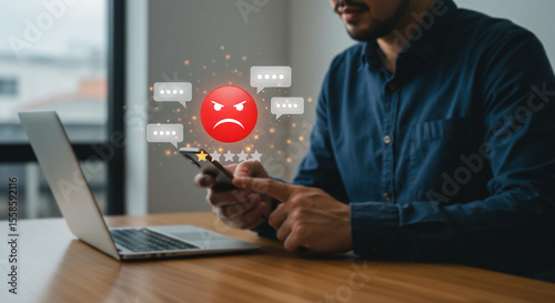 Negative Review: A person holding a smartphone with a red angry face emoticon displayed, symbolizing negative feedback and customer dissatisfaction on screen.