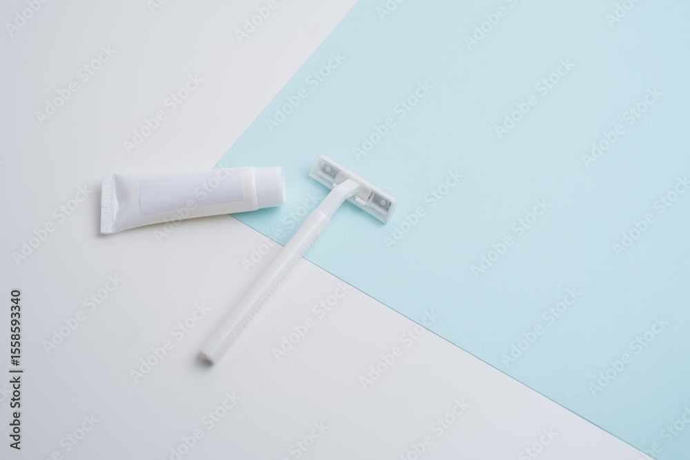 Fototapeta premium Disposable plastic razor with steel blade, men's and women's razors and shaving cream. Skin and body care concept. Depilation. Space for text