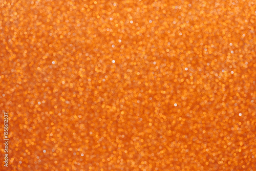 Colorful orange glitter bokeh background vibrant for holiday design textures