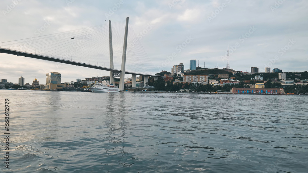 Fototapeta premium Scenic view of zolotoy rog bay featuring the iconic golden bridge and vladivostok cityscape in russia