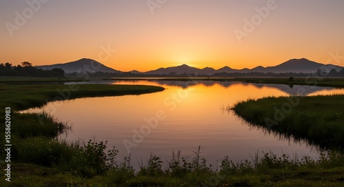 Serene Sunrise over Calm Lake and Mountain Range