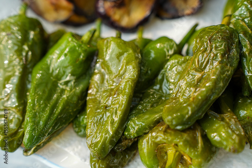 Fried Pimientos de Padron - green pepper-  and eppglants  on a Plate