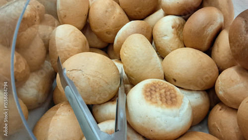 Fotografie baked bread rolls in a self-service bakery container in supermarket