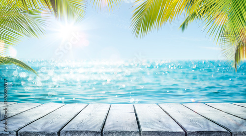 Tropical Summer Table - Sea And Empty Wooden Table With Palm Leaves - Flare Effect And Abstract Bokeh Light In Defocused Ocean