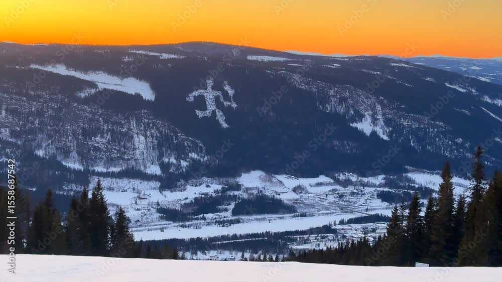 Olympic torch man on top of Øyer mountain Lillehammer Hafjell Alpine resort Norway Norge chairlift steep groomed trail ski runs golden hour vibrant sunset winter terrain landscape frigid parallax left