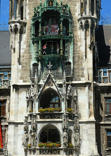 Munich, Marienplatz: detail of the rich gothic architecture of the main tower of the New Town Hall with the statues of the first four Bavarian kings and  the carillon with coopers dancing and knights