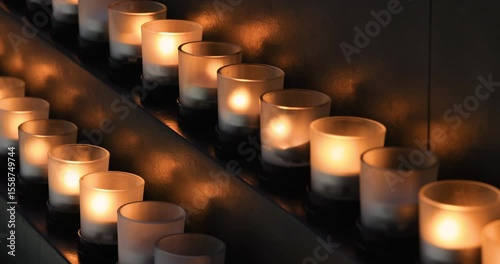Memorial candles flicker in dark room religion. Remember and sorrow for those who have passed and died before. Religion and faith in church and cathedral. 4K HD video footage.