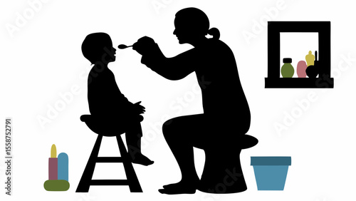 Silhouette of a mother feeding her child sitting on a high chair with a spoon near a window and toys