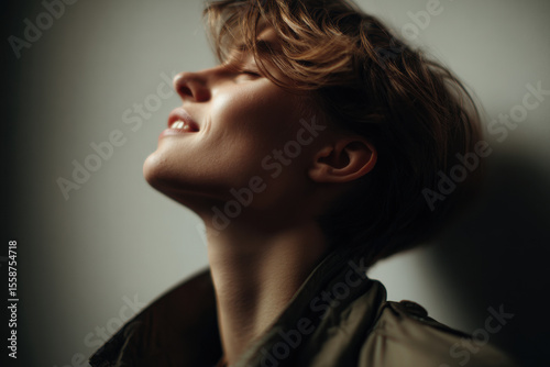 circus artist in profile displaying intense and joyful emotion on their face
