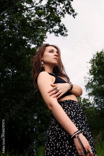 A girl's outfit styled after the indigenous peoples of the world. International Day of the World's Indigenous Peoples. Against the backdrop of nature.