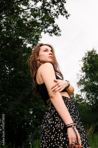 A girl's outfit styled after the indigenous peoples of the world. International Day of the World's Indigenous Peoples. Against the backdrop of nature.