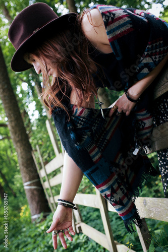 A girl's outfit styled after the indigenous peoples of the world. International Day of the World's Indigenous Peoples. Against the backdrop of nature.