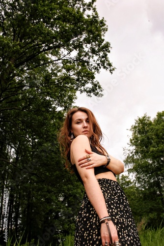 A girl's outfit styled after the indigenous peoples of the world. International Day of the World's Indigenous Peoples. Against the backdrop of nature.