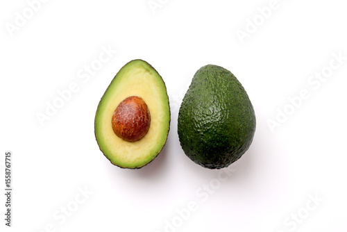 Avocado cut in half and a whole avocado on a white background
