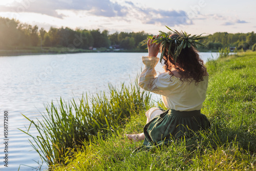 Serene Ukrainian Woman in Vyshyvanka with Wheat Wreath by Lake at Sunset, Ivana Kupala Mavka Theme, Slavic Folklore and Nature Connection.