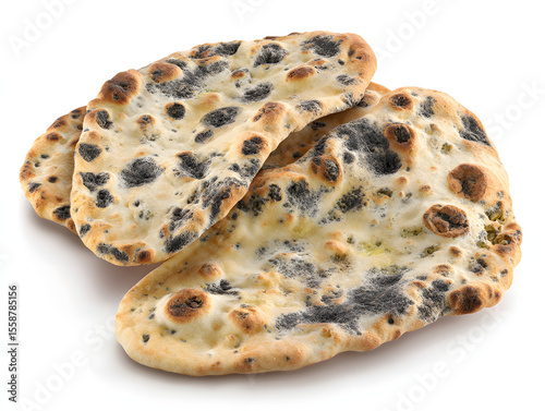 Moldy naan bread with dark black fungal patches , isolate on white background.
