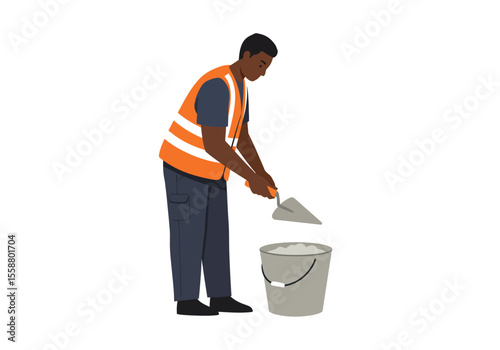 Man in vest shoveling cement into bucket dark hair black boots