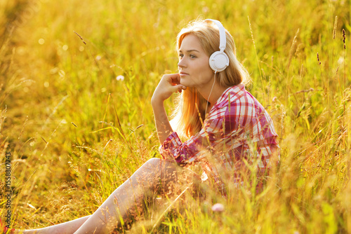Happy girl listening to music on headphones.