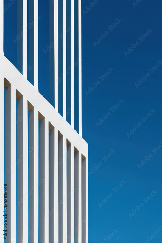 Fototapeta premium Geometric Play of Light and Shadow on a Modern Facade with Vertical Lines