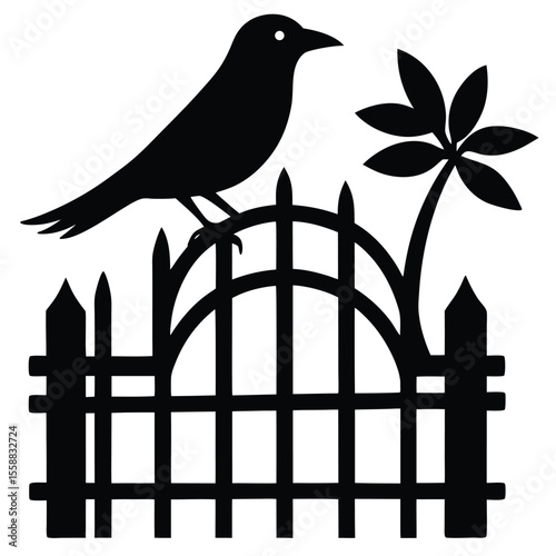 Black silhouette of a crow perched on a decorative garden fence with a plant