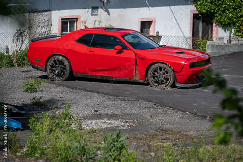 Wallpaper Mural Damaged section of a red sports car with muddy wheels, captured in natural outdoor light,  Torontodigital.ca