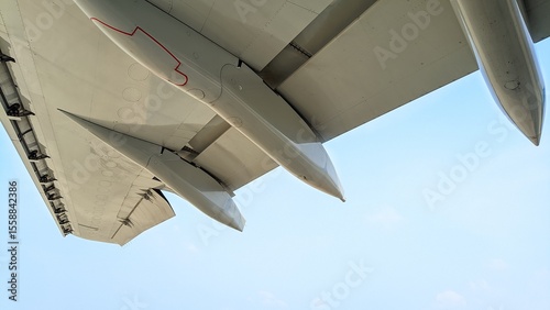 Close-up photo of an aircraft wing taken from below with the canoe fairing and slats
