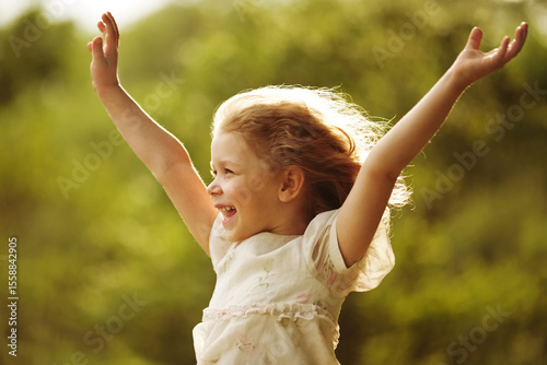Girl with arms outstretched to the sides.