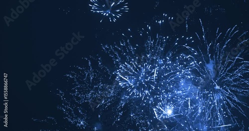 Fireworks in evening sky during celebration. The color is blue