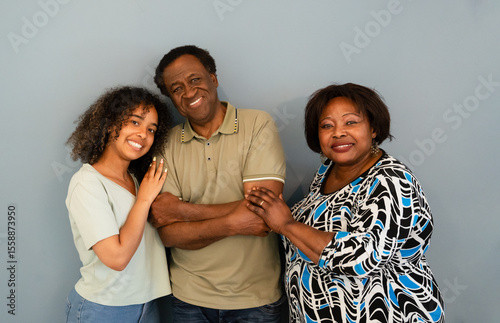 Happy family portrait against gray background