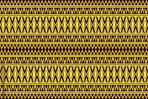 Seamless tribal geometric pattern in yellow and brown with repeating traditional ethnic design.