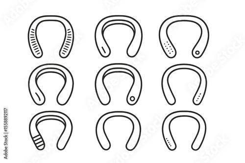 Various designs of horseshoes arranged in a grid on a plain background