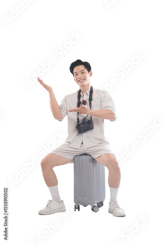 Ready to Explore: A young, adventurous person prepares for a journey, seated atop a travel suitcase with a camera around their neck.