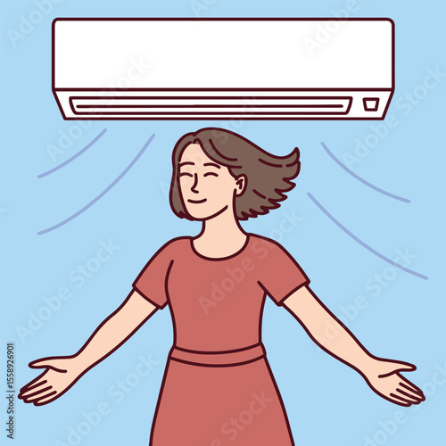 Woman stands under air conditioner with raised arms enjoying airflow. She stays cool and relaxed on hot summer day indoors
