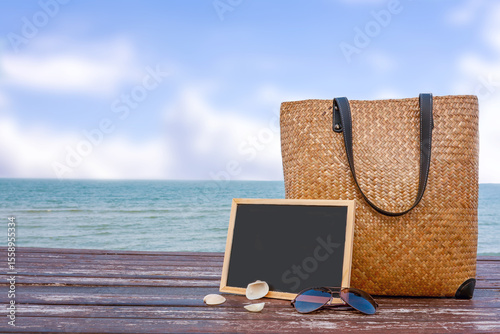 bamboo bag and chalkboard on wooden floor.